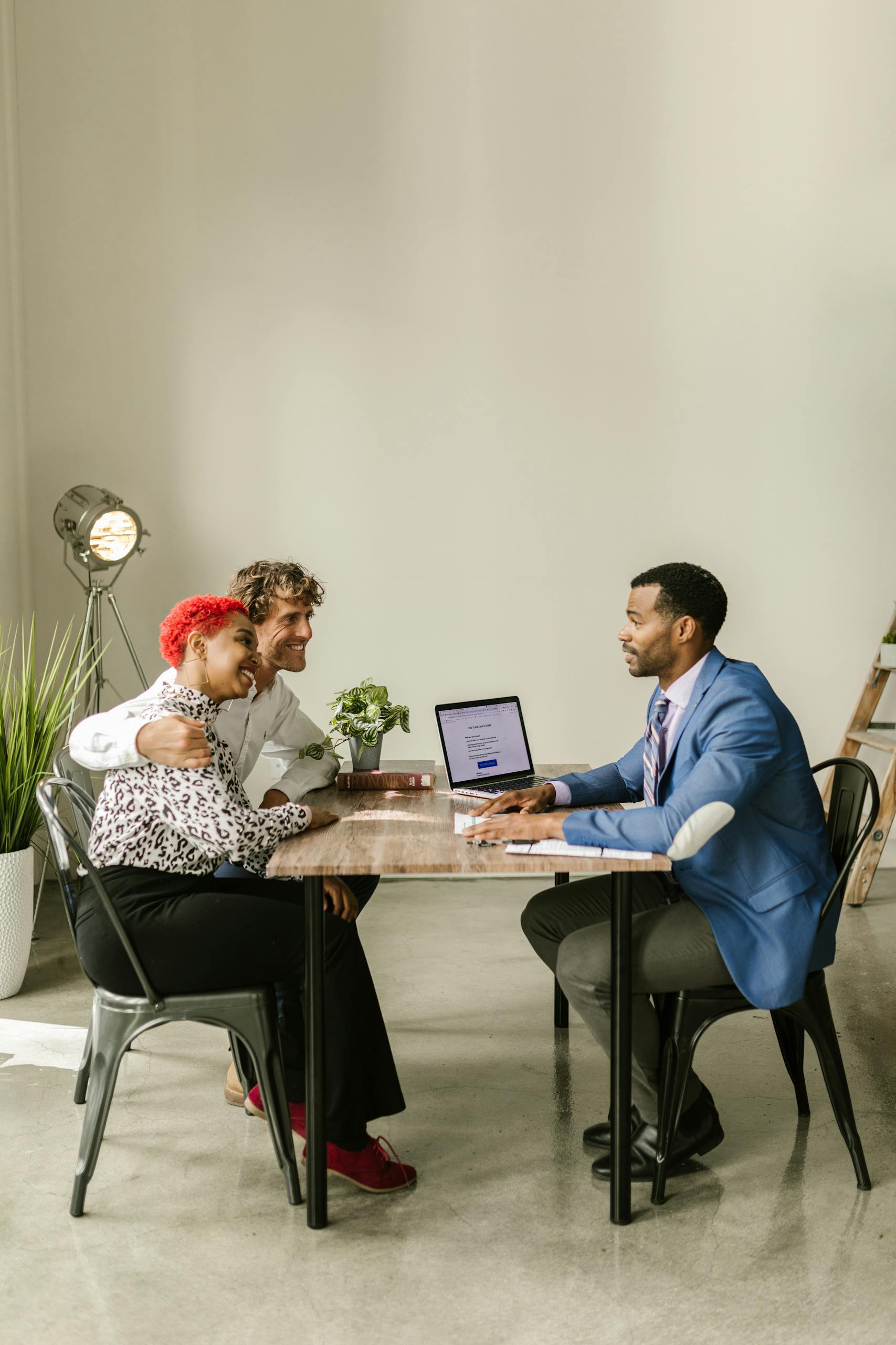 Insurance 14 A professional financial advisor discusses options with a couple in a modern office setting.