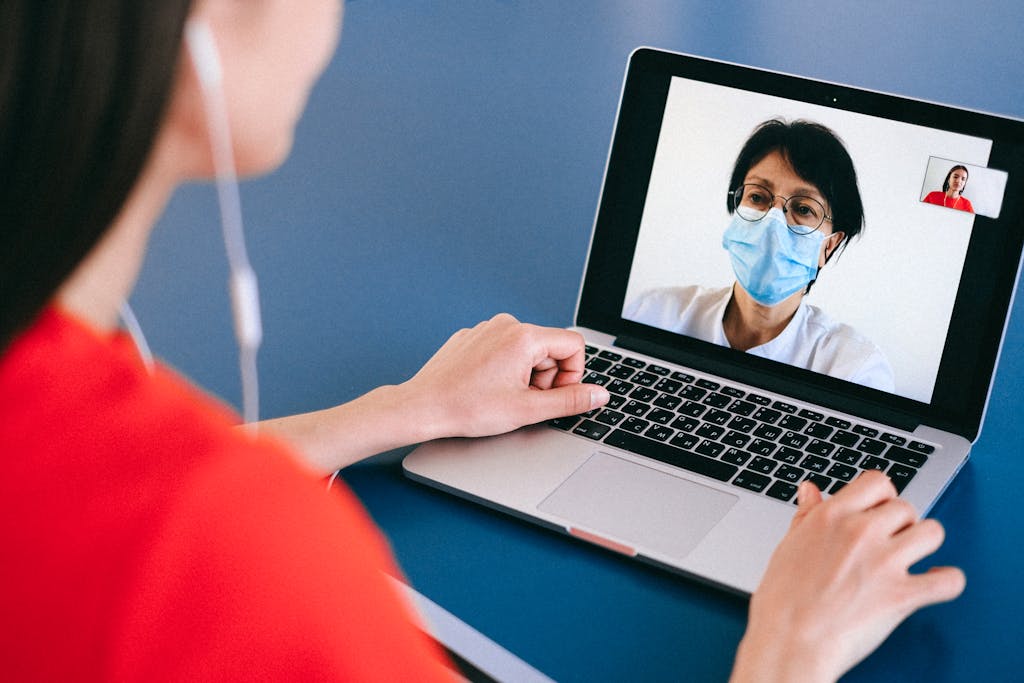 Pharma 11 Doctor and patient on a video call for telehealth consultation during COVID-19 era.