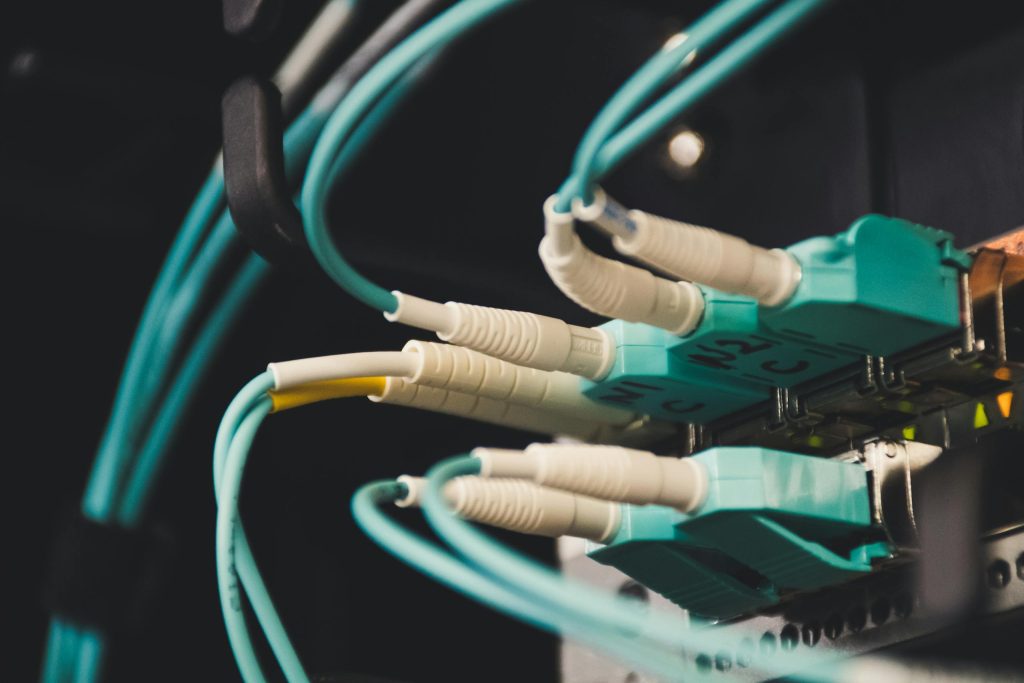 Construction & Logistics 11 Detailed view of fiber optic cables and ports in a server room, showcasing connectivity.