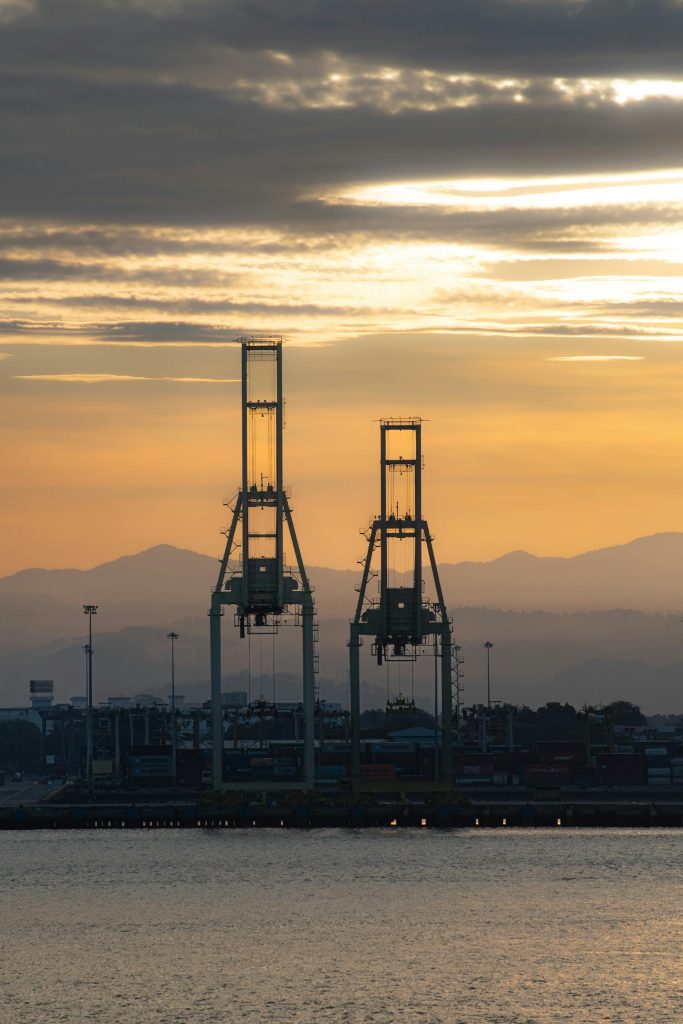 Oil & Gas 14 Serene sunset view of cargo cranes at Penang Port, Malaysia highlighting industrial beauty against nature.